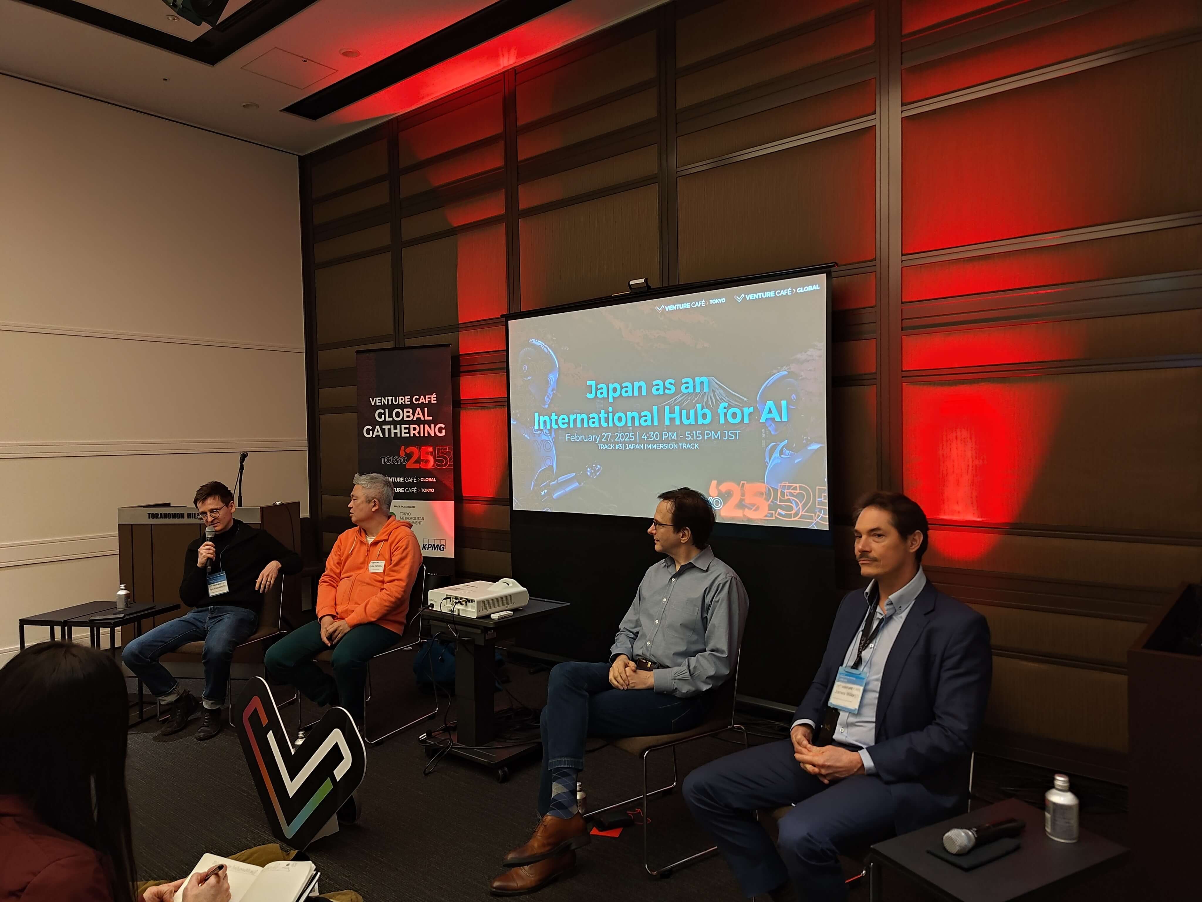 Four speakers on stage discussing ‘Japan as an International Hub for AI’ at the Venture Café Global Gathering Tokyo 2025.